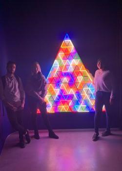 students with illuminated rainbow triangle